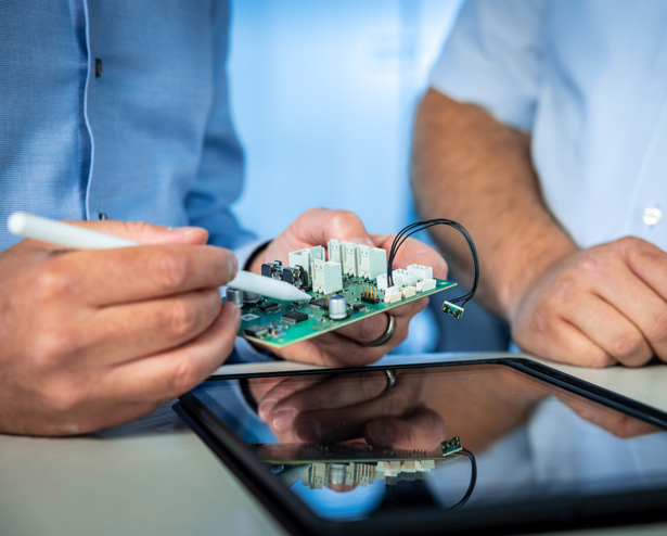 technician inspecting circuit board