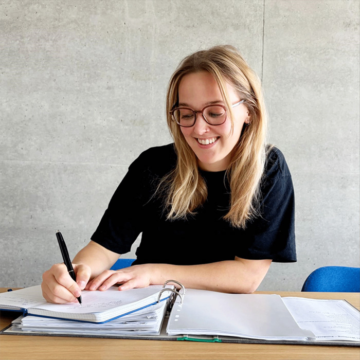 watson in the office writing on a piece of paper